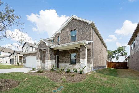 View of front of property featuring a garage and a front yard