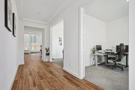 Home office with wood-type flooring