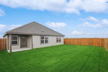 Back of house with a yard and a patio