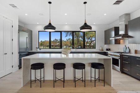 Stunning window backsplash enhances the light-filled, open kitchen.