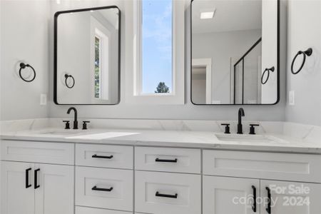 Primary bath with dual vanities. Quartz counter tops. Soft close drawers and cabinets