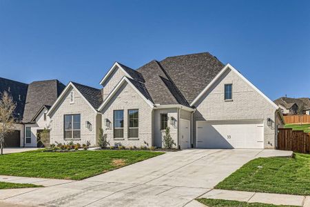 View of front of home featuring a front lawn and a garage