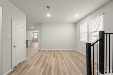 Empty room with light hardwood / wood-style flooring