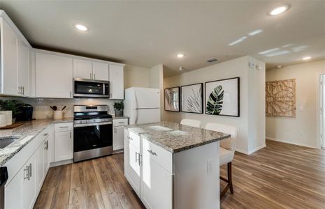 Bright kitchen with oversized island  *Photos of furnished model. Not actual home. Representative of floor plan. Some options and features may vary