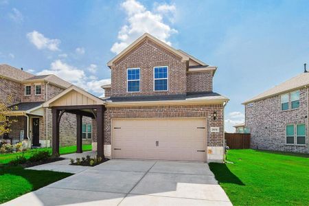 View of front of house with a garage and a front yard