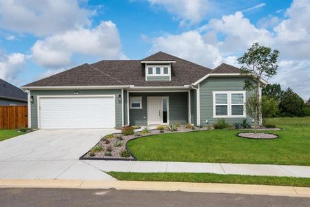 View of front of home with a garage and a front yard