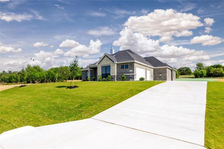 View of front of property with a garage and a front yard