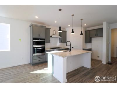 Beautiful kitchen with soft close cabinetry, built-in combo microwave and coven, 36" hood vent and cook top, granite countertops and an under-mounted sink.