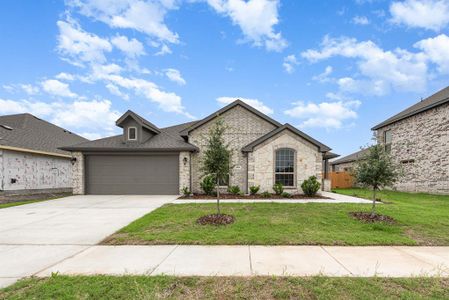 French provincial home with a garage and a front lawn