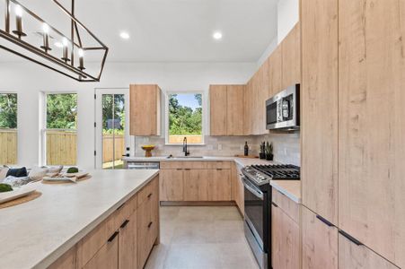 Soft-close cabinetry is a sleek arcadia yellow walnut.