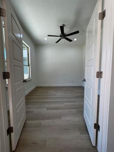 Empty room featuring hardwood / wood-style flooring and ceiling fan