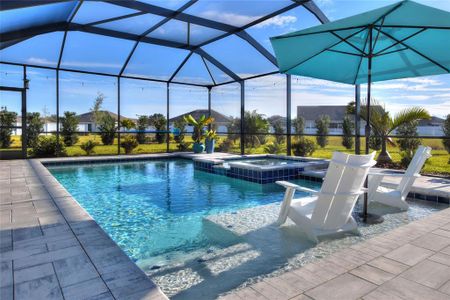 Enclosed heated saltwater pool, with tanning ledge and jacuzzi.