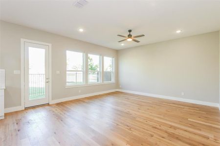 Empty room with light hardwood / wood-style flooring and ceiling fan