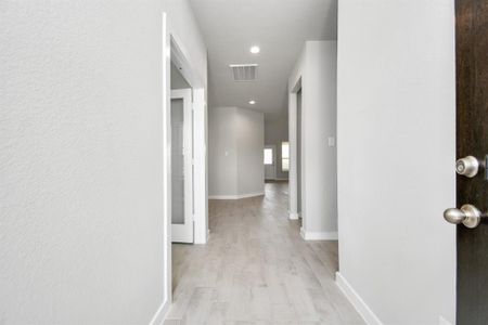 Experience luxury as you step into the threshold of this breathtaking home. The grand entrance beckons with its high ceilings, recessed lighting, and elegant wood-look tile flooring combined with oversized baseboards. Sample photo, as built color and selections will vary.