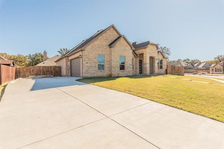 View of front of home featuring a front yard and a garage