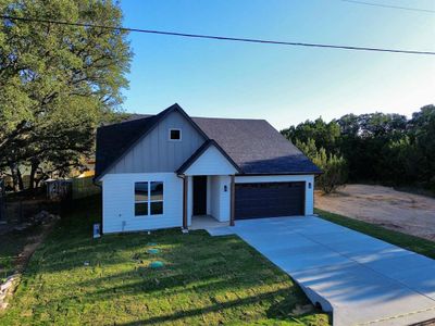 View of front of house featuring a garage and a front yard