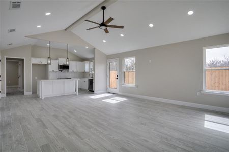 Unfurnished living room with visible vents, baseboards, beam ceiling, ceiling fan, and light wood-style floors