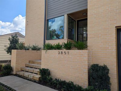 Walk up the path lined with plants to your front door.