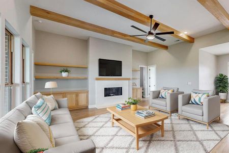 Virtual Staged Living room featuring ceiling fan, beamed ceiling, and light hardwood / wood-style flooring