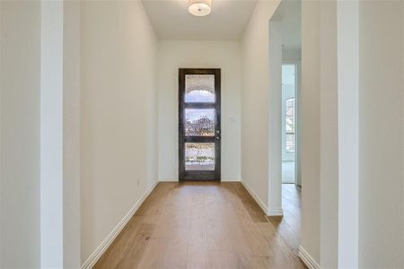 Entrance foyer with wood-type flooring