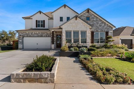 Beautifully landscaped front yard and a clean driveway that leads to a 2-car garage.