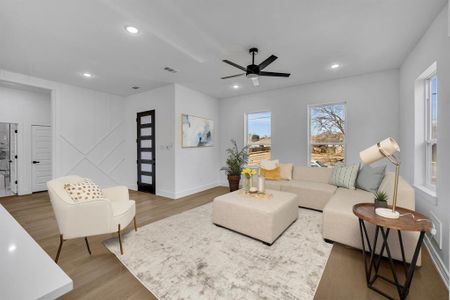 Living room featuring dark wood-type flooring and ceiling fan