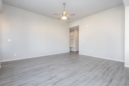 Unfurnished room with light wood-type flooring and ceiling fan