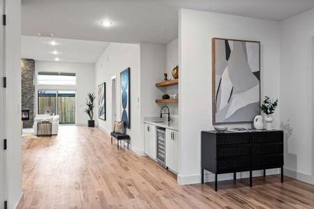 Hall featuring light wood-type flooring, sink, and wine cooler