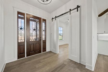 Entryway with hardwood / wood-style flooring and a barn door