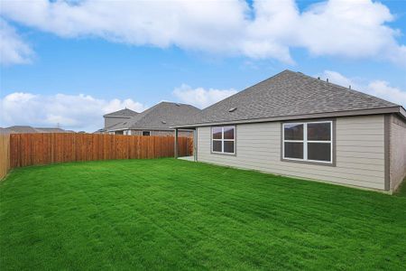 Back of house featuring a yard