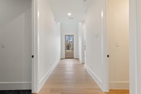 Hallway with light hardwood / wood-style floors