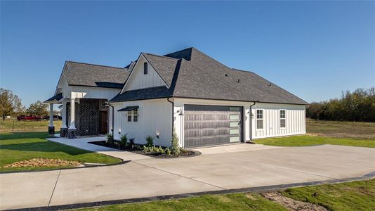 View of side of home with a yard