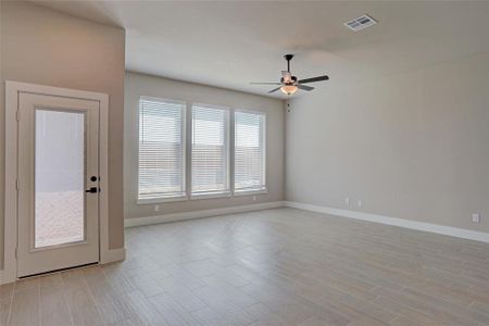 Spare room with ceiling fan and light hardwood / wood-style floors