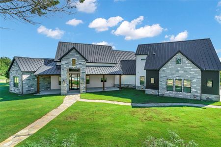 Modern farmhouse style home featuring a front yard