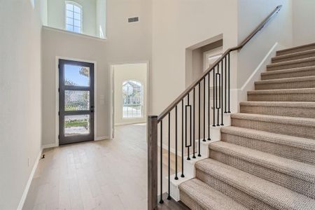 Foyer entrance featuring a high ceiling and hardwood / wood-style floors