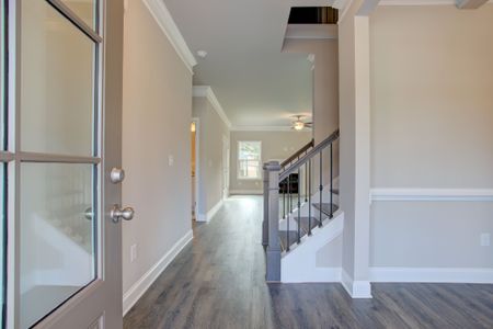 The inviting foyer opens to the staircase and the formal dining room