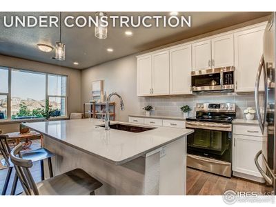 Kitchen- Photos of a previously built unit.  Cabinet layout and finishes may vary.