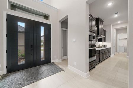 Double doors leading to high ceiling at entry