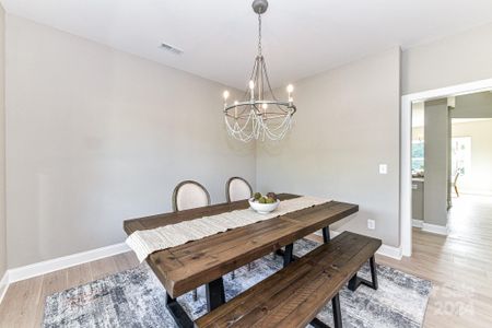 Formal Dining Room features custom light fixture & LVP floors!