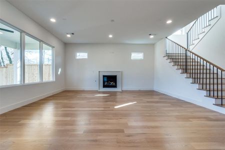 Unfurnished living room with light hardwood / wood-style floors