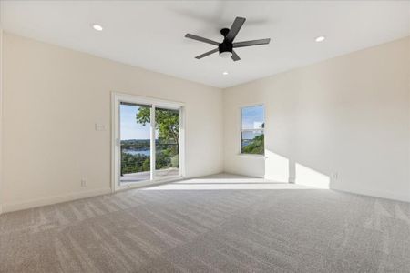 Carpeted spare room with ceiling fan