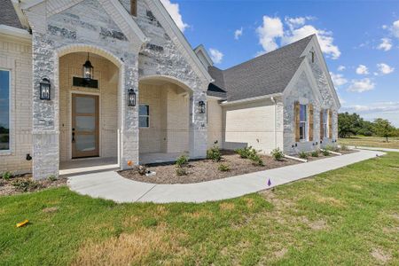 View of front of home with a garage and a front yard