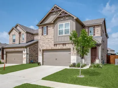 Craftsman inspired home featuring board and batten siding, a garage, driveway, brick siding, and a shingled roof Craftsman inspired home featuring board and batten siding, a garage, driveway, brick siding, and a shingled roof