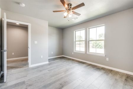 Unfurnished room with ceiling fan and light hardwood / wood-style floors