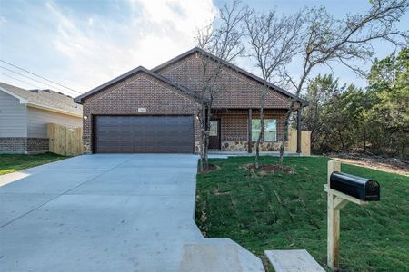 View of front of house with a front yard and a garage