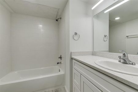 Bathroom with vanity and tiled shower / bath combo