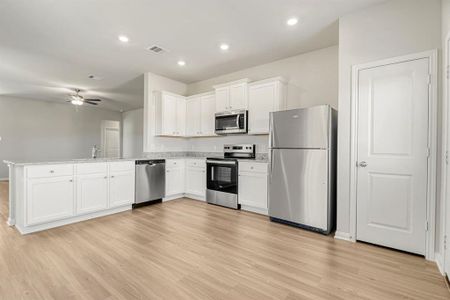 The kitchen is upgraded with Whirlpool appliances and granite countertops.