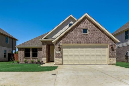 View of front of property featuring a garage and a front lawn