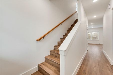 Stairway with hardwood / wood-style floors