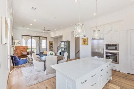 The open concept dining and living areas open to a 10' tall wall of glass panels that stack open, leading to a covered balcony, similar to this previous build.